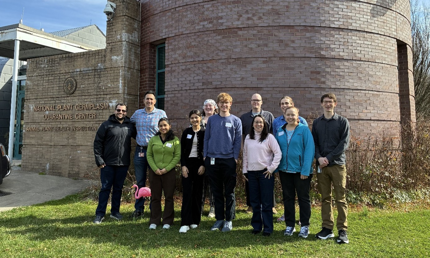 A group photo in front of a brick building