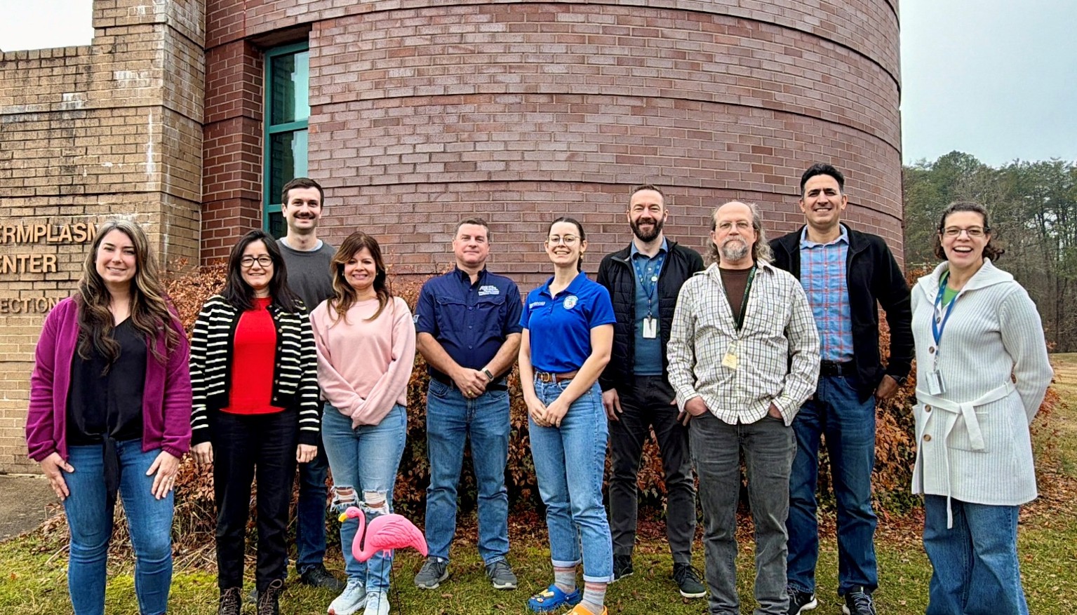 Group photo in front of a brick building