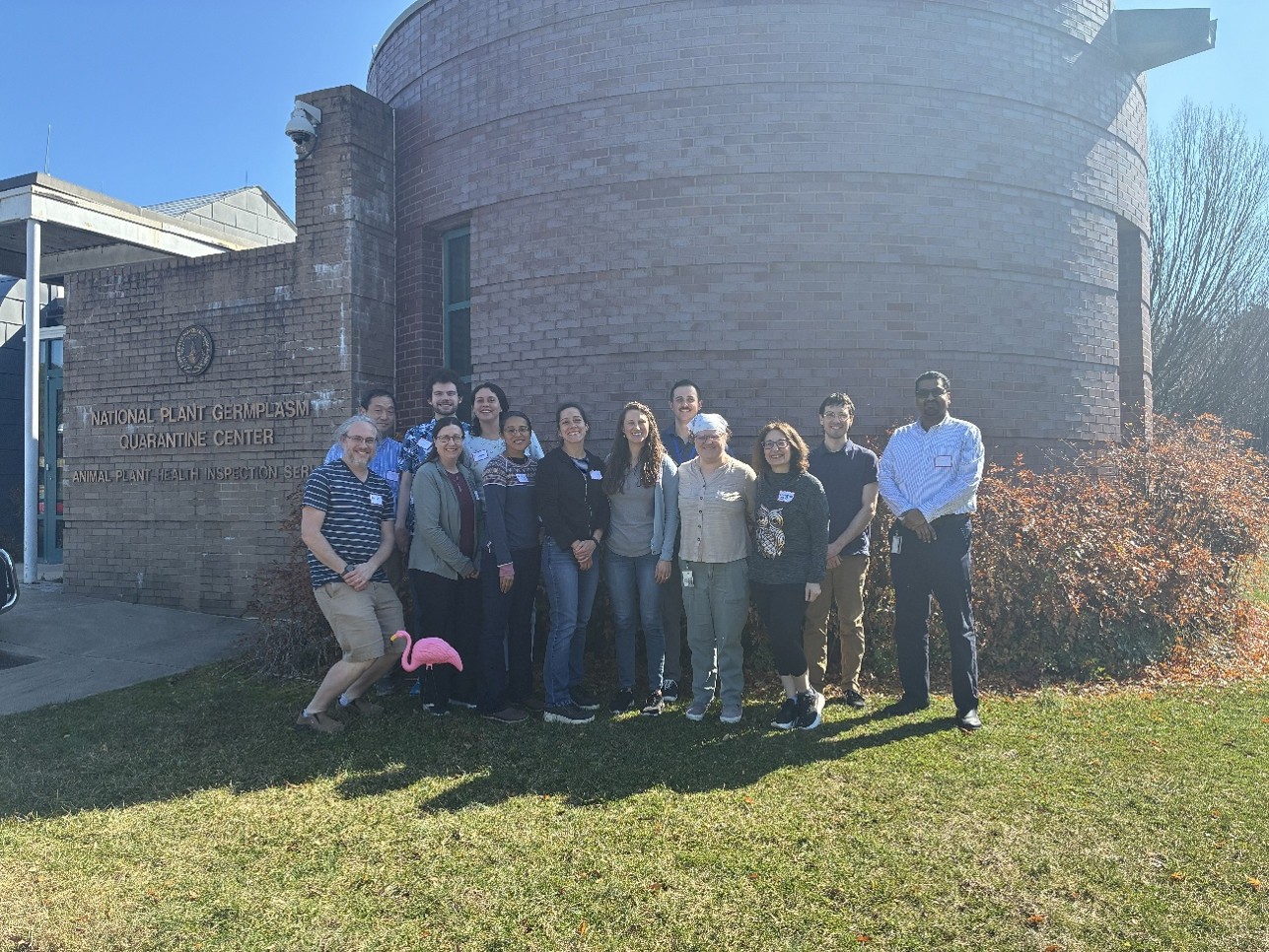 A group photo in front of a brick building